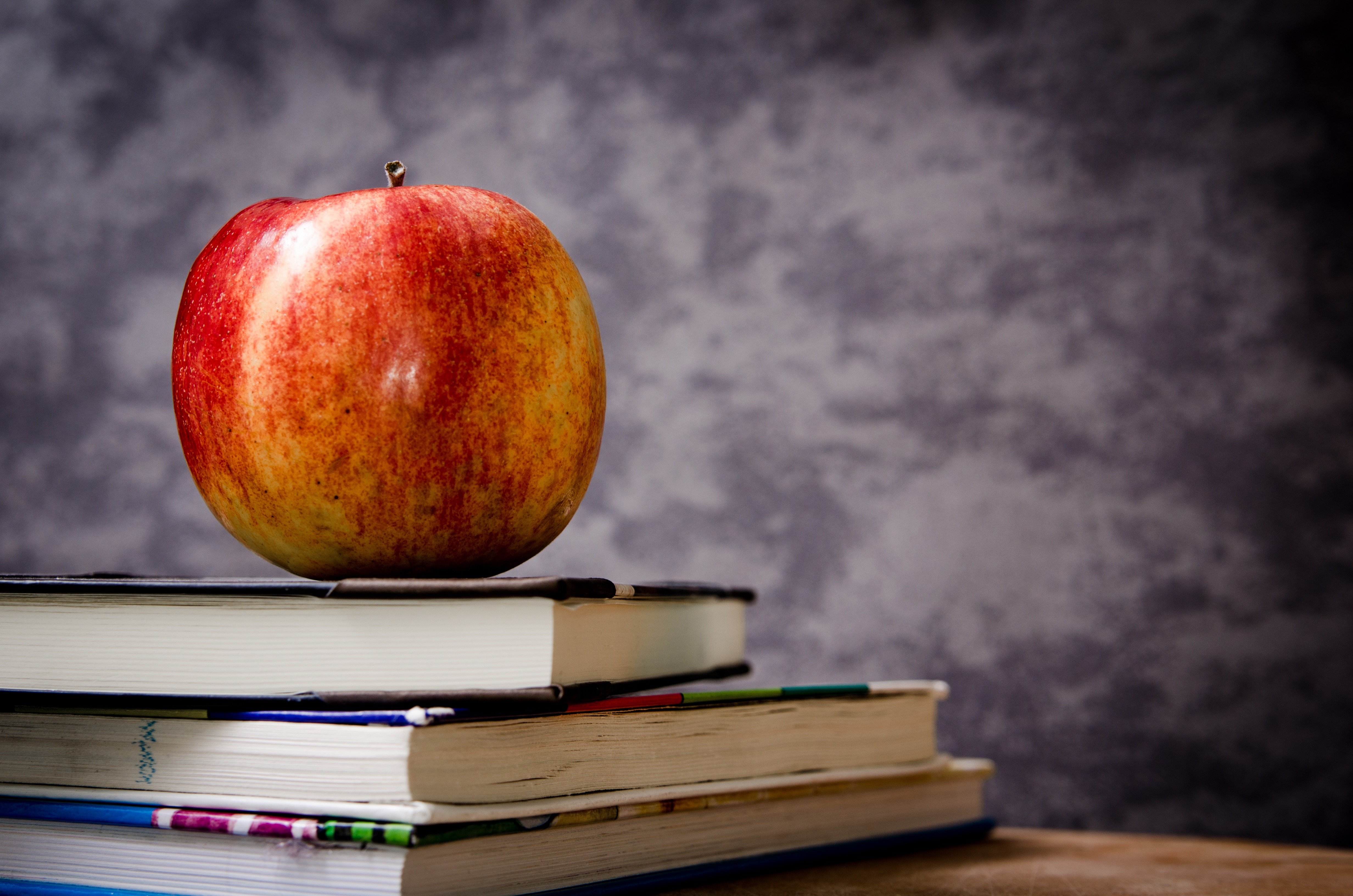 School classroom, apple resting on top of some books