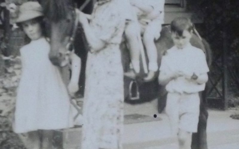 1942 photo of Genevieve (age 7) leading "Molly", the pony with two evacuees on her