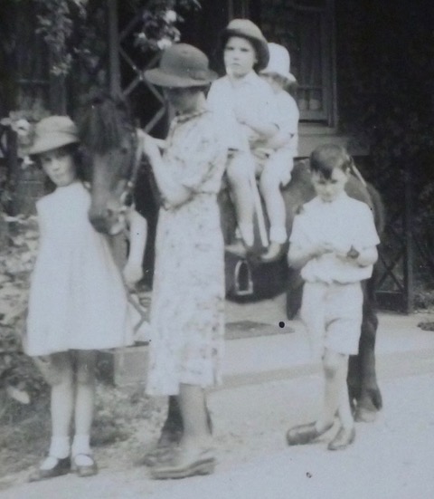 1942 photo of Genevieve (age 7) leading "Molly", the pony with two evacuees on her